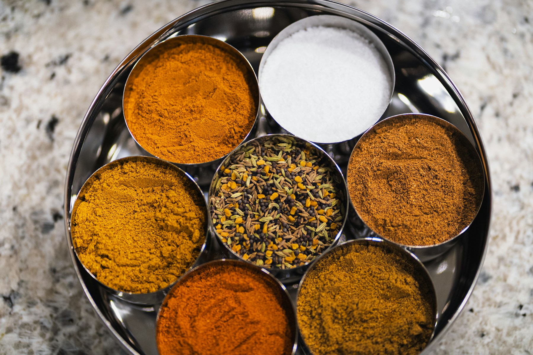 Indian spices and seasoning powders in metal bowls